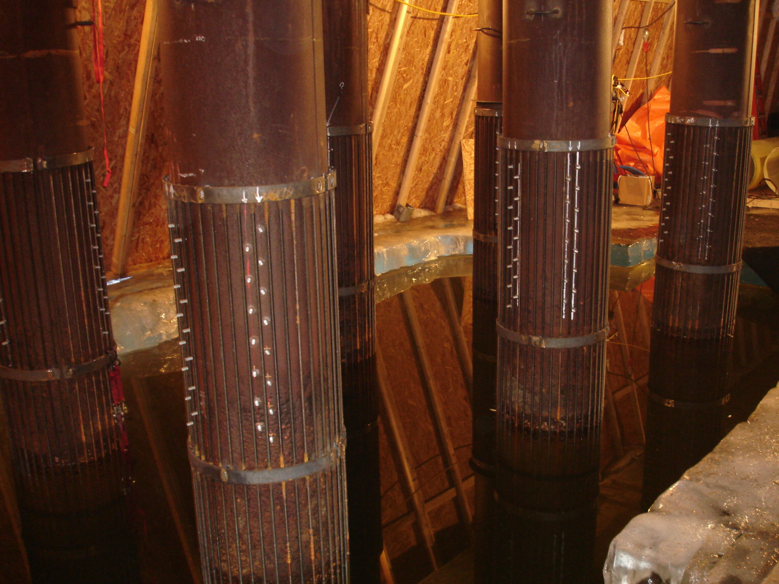 Piles with reinforcing cages and sheer studs prior to jacketing.