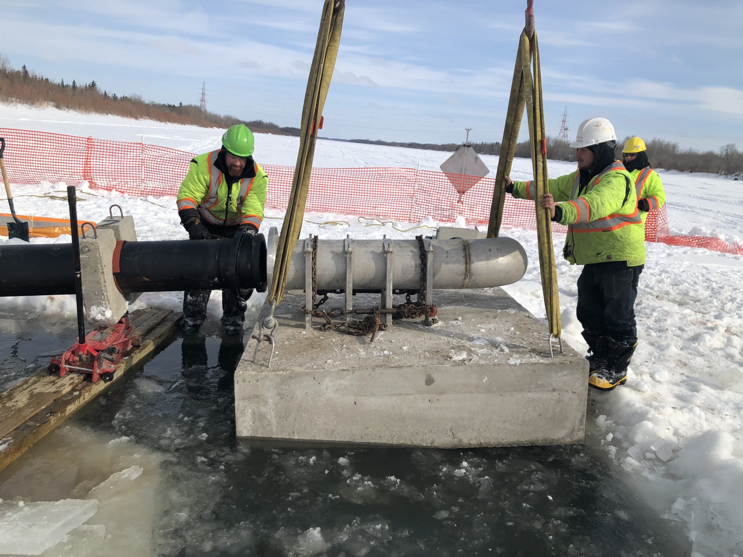 Installing a water intake structure from the ice.