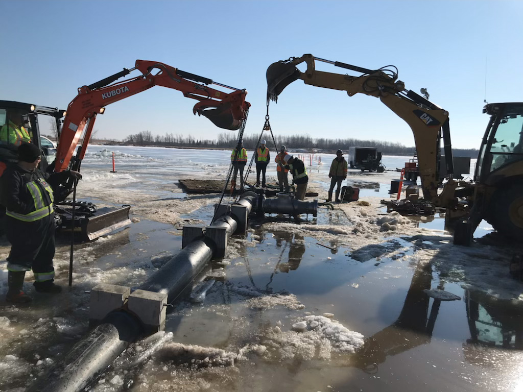 Installing water intake line from the ice.
