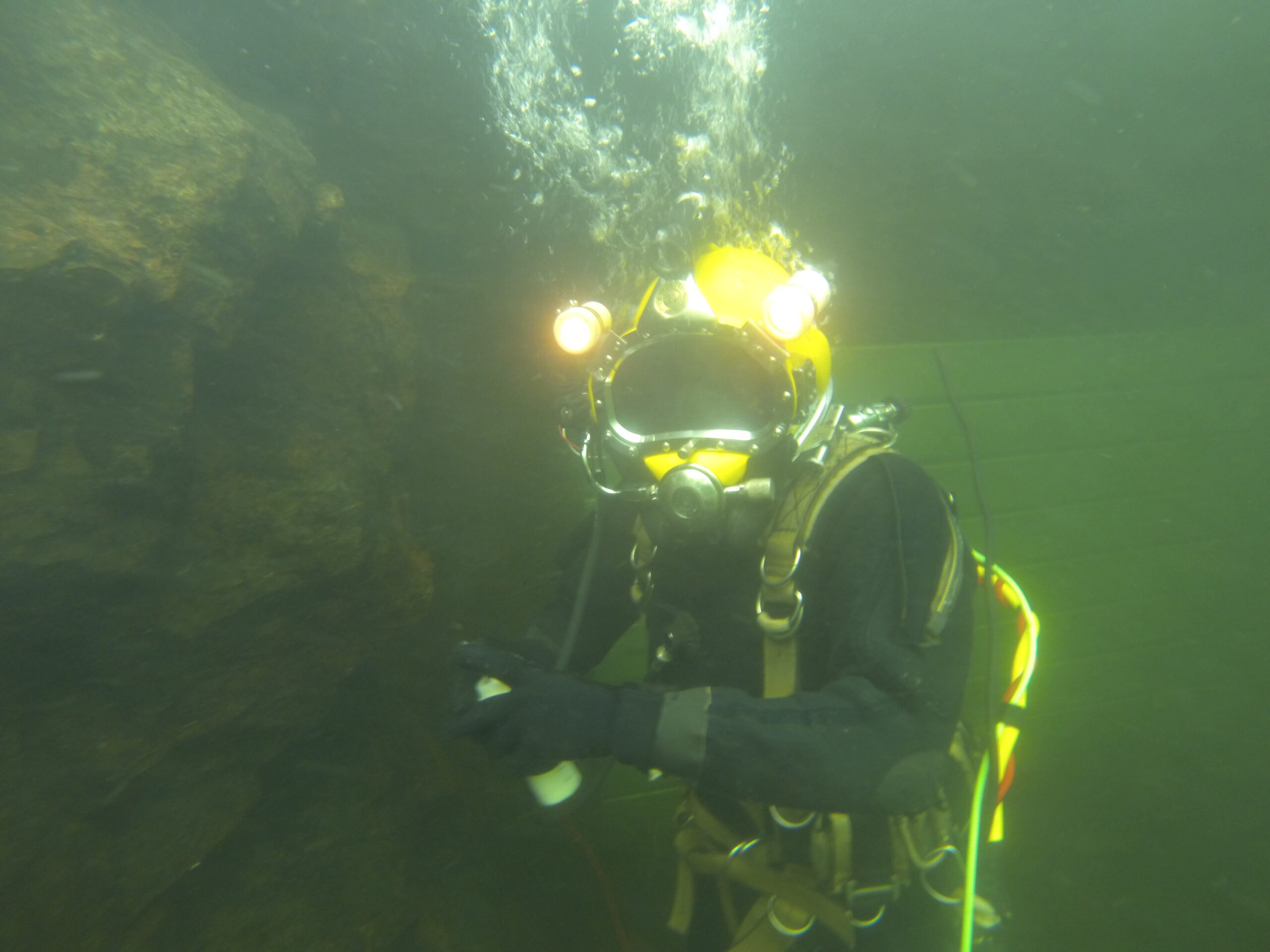 Diver investigating leakage through a dam.