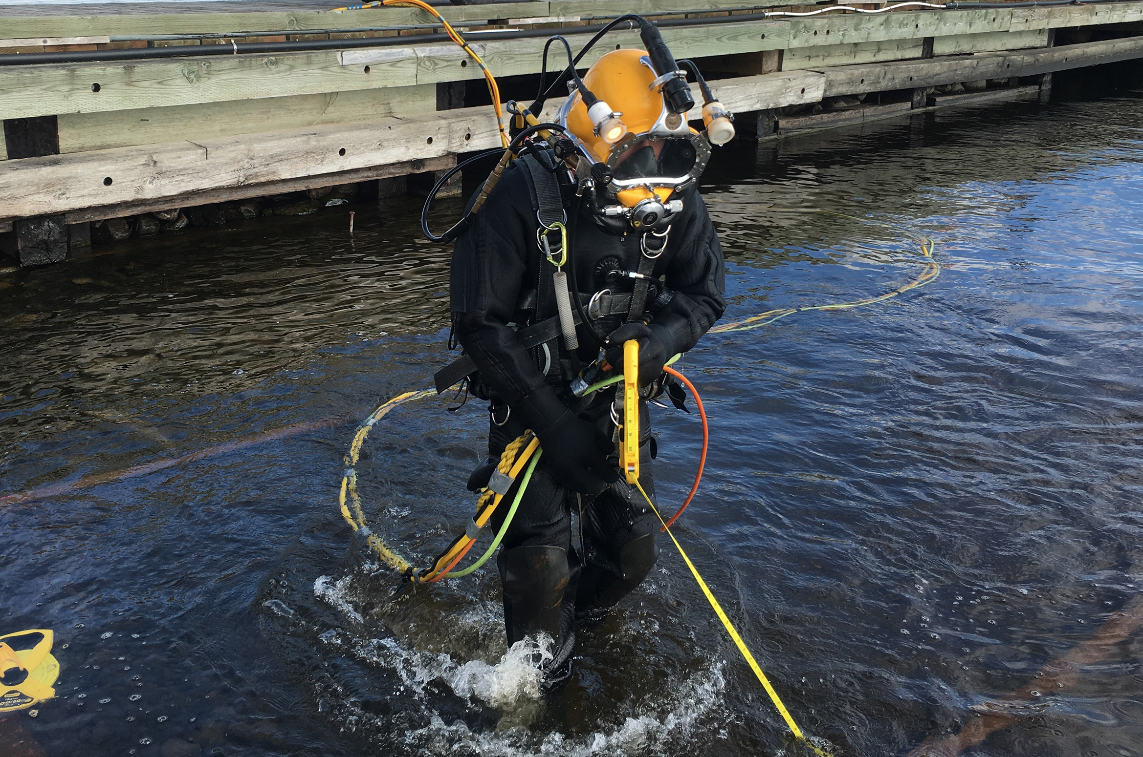 Diver preparing to carry out a video inspection on a wharf.
